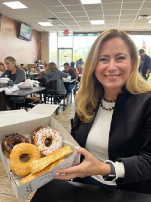 Debbie Mucarsel-Powell holding a box of donuts.